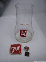 7Up Uncola glass with badge and two pins visible