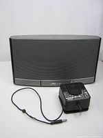 Front view of Bose SoundDock Portable with power adapter