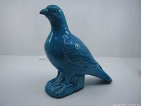 Left side view of blue porcelain pigeon figurine