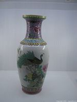 Full view of vase front showing peacock and floral decoration