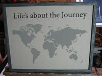 Front view of framed cloth art displaying map graphic and text