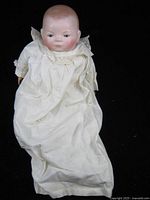 Full view of Grace S Putnam bisque baby doll in long white gown