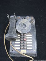 Front view showing handset, bells, buttons and cord