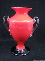 Front view showing red body, clear handles, black foot