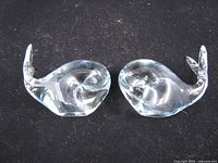 Both handblown glass whale paperweights side by side