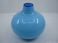 Front view of baby blue glass vase showing shape and color