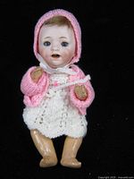 Full view of doll in knit outfit