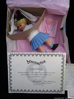 Doll in open box with certificate visible