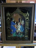 Front view of framed reverse glass Holy Family artwork in wood frame