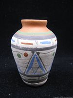 Front view of small hand-painted Southwestern clay vase