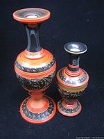 Both wood lacquer candlesticks standing side by side showing decoration and relative sizes