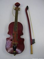 Front view of wooden violin ornament and bow