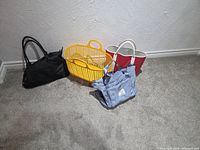 All four tote bags side by side on carpet