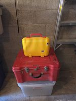 Small yellow case stacked on large red case