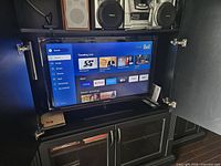 Television powered on in cabinet showing Bell interface