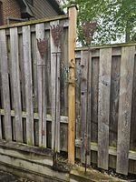 All three iron garden decorations against fence