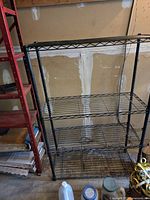 Front view of entire black metal shelving unit.