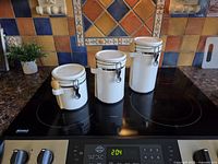 Front view of all three ceramic canisters on stovetop