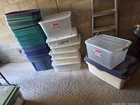 Stack of blue and teal bins next to clear and ivory bins