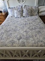 Entire bed with quilt, shams, pillows visible