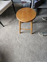 Stool front three-quarter view showing size, leg style and finish