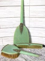 Front view of brush, mirror back and comb showing green bodies and metal trim