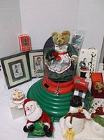 Overview of tree stand, plush figures, framed art, wood plaques and ornament