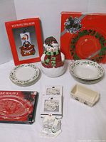 Group shot of all items including cookie jar, bowls, loaf pan, coasters, plates and towel holder kit