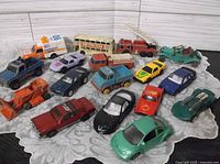 Group shot of all 17 die-cast vehicles on lace cloth