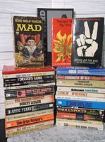 Overall view showing two stacks of paperback books and three featured titles standing upright