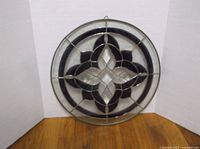 Full view of round stained glass panel showing overall design and frame