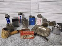 Full lot showing all lighters, ashtray, pipe, filter box