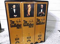 Front view of three film slipcovers in collection outer case