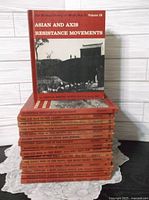 Stack of 16 uniform red hardcover volumes, top book Asian and Axis Resistance Movements