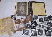 overview showing binder open, autograph page, stacks of photos, clippings, ticket stub
