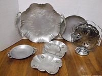All five hammered aluminum serveware pieces grouped