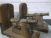 Both wooden bookends front view showing cannons