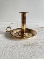 Side view showing brass chamberstick with stem and finger loop