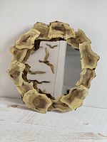 Front view of round mirror tray showing welded metal rim