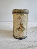 Front view showing windmill vignette and floral borders on cookie tin