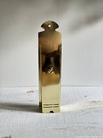 Front view of brass match holder showing pocket and hanging tab