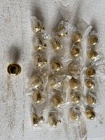 overview of group of brass knobs, many in plastic