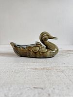 Left profile of glazed ceramic duck dish