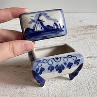 Open trinket box showing interior, lid with windmill scene