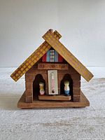 front view showing thermometer, figurines, cross-beam roof