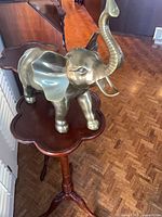 Full view of brass elephant on stand
