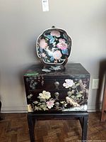 Cabinet with porcelain bowl on top, showing painted details and brass hardware