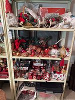 Full view of four shelves filled with assorted Christmas decorations