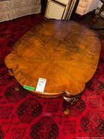 Top view showing oval shape, wood grain, scalloped edge