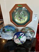 Group shot of all four plates (one framed) with three stands